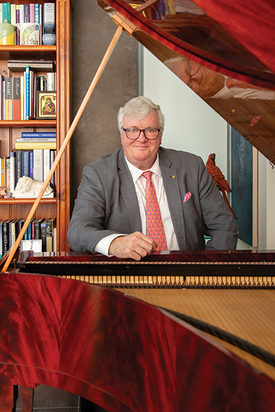 Geoffrey Lancaster sits at grand piano