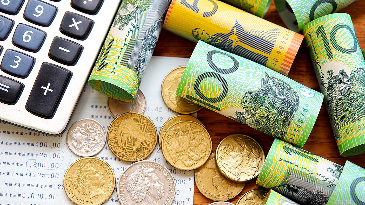 High angle view of currency and calculator on table - stock photo