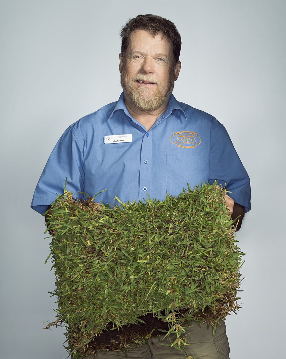 Portrait of John Forrest holding some turf