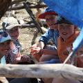 Hut building participants inside a hut they have built